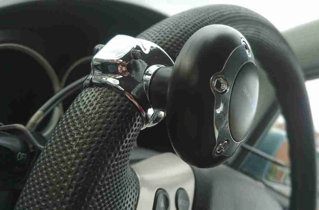 a steering knob attached to the steering wheel. It is bolted on